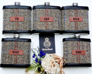 Five Harris Tweed hip flasks with initials on leather labels