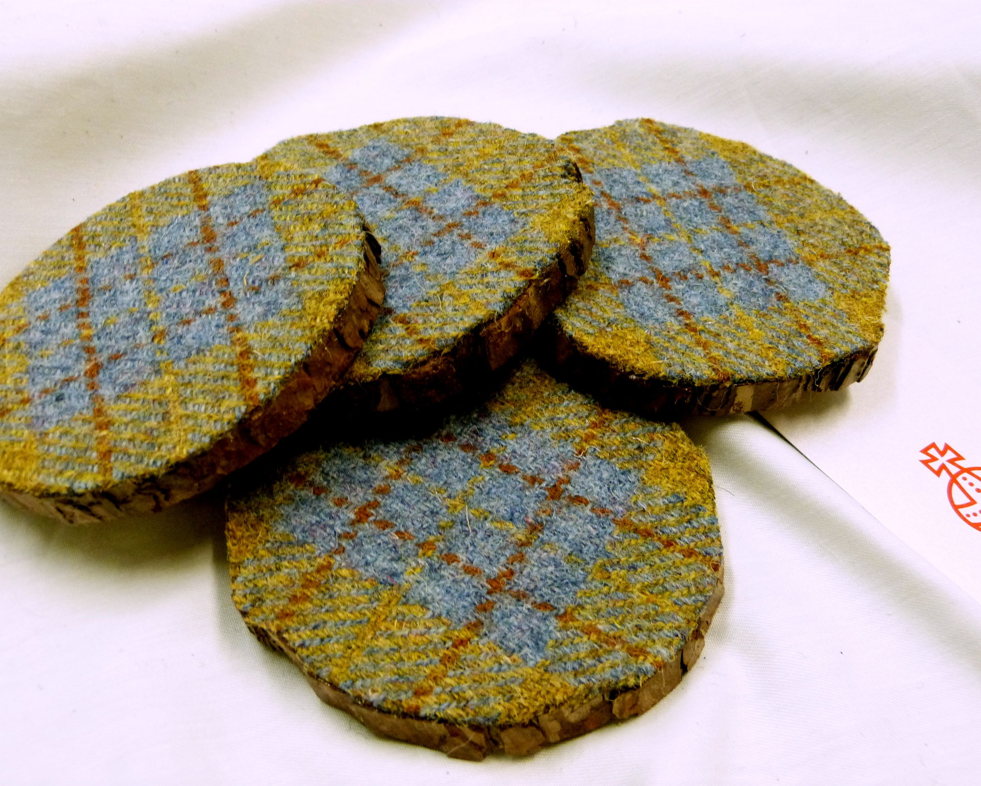 Log slice coasters with Harris Tweed in Blue, mustard yellow and russet plaid, ideal gift handmade in Scotland