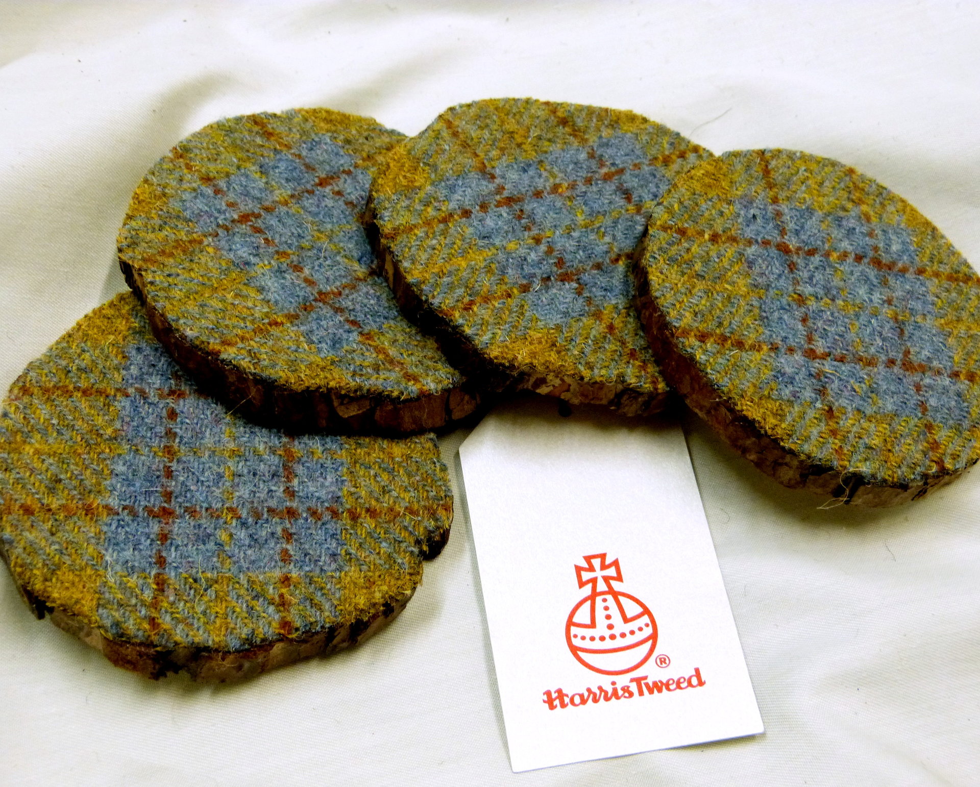 Log slice coasters with Harris Tweed in Blue, mustard yellow and russet plaid, ideal gift handmade in Scotland